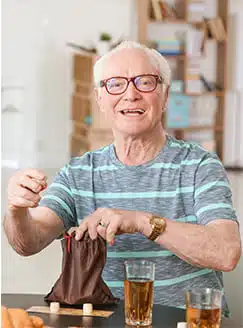 Senior man playing games and smiling.